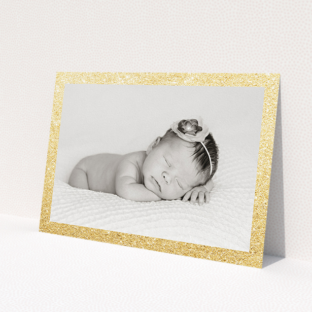 A birth announcement card called 'All that Glitters'. It is an A5 card in a landscape orientation. It is a photographic birth announcement card with room for 1 photo. 'All that Glitters' is available as a flat card, with tones of gold and white.