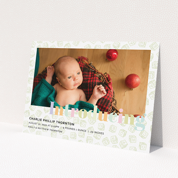 A birth announcement card called 'Alphabet Blocks'. It is an A5 card in a landscape orientation. It is a photographic birth announcement card with room for 1 photo. 'Alphabet Blocks' is available as a flat card, with tones of green and purple.
