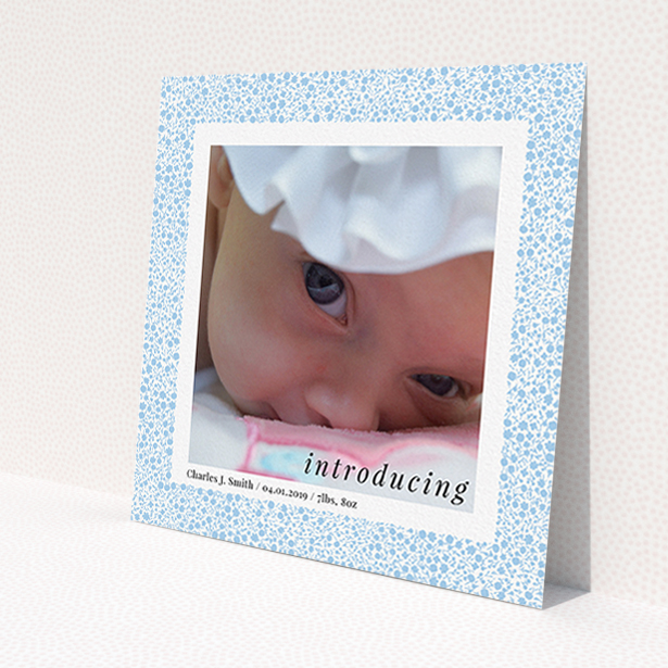 A birth announcement card design titled 'Baby Blue Floral'. It is a square (148mm x 148mm) card in a square orientation. It is a photographic birth announcement card with room for 1 photo. 'Baby Blue Floral' is available as a flat card, with tones of blue and white.