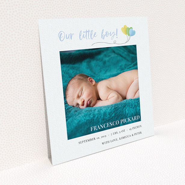 A birth announcement card design titled "Balloooons". It is a square (148mm x 148mm) card in a square orientation. It is a photographic birth announcement card with room for 1 photo. "Balloooons" is available as a flat card, with mainly blue colouring.