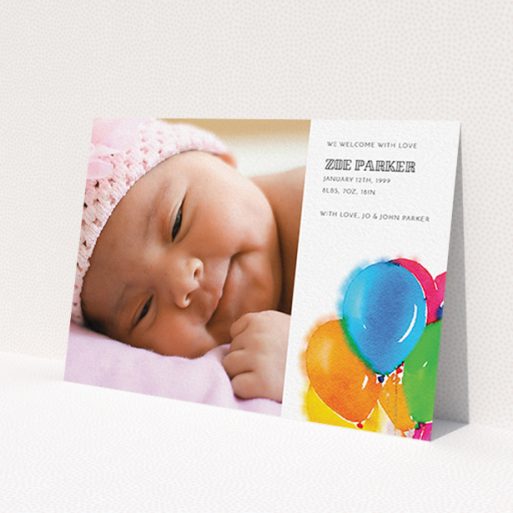 A birth announcement card design titled 'Big Balloons'. It is an A6 card in a landscape orientation. It is a photographic birth announcement card with room for 1 photo. 'Big Balloons' is available as a flat card, with tones of white, orange and blue.