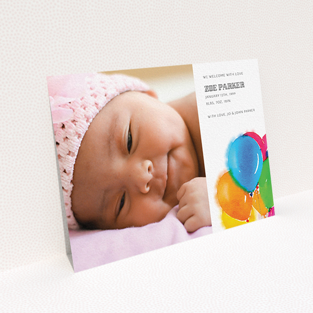 A birth announcement card design titled "Big Balloons". It is an A6 card in a landscape orientation. It is a photographic birth announcement card with room for 1 photo. "Big Balloons" is available as a flat card, with tones of white, orange and blue.