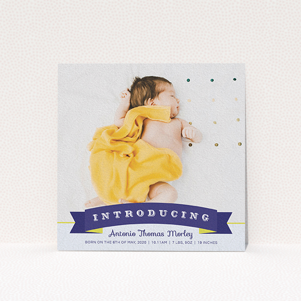 A birth announcement card design named "Big Banner". It is a square (148mm x 148mm) card in a square orientation. It is a photographic birth announcement card with room for 1 photo. "Big Banner" is available as a flat card, with tones of blue, light blue and yellow.