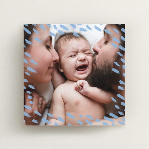 A birth announcement card called "Blue Dashes". It is a square (148mm x 148mm) card in a square orientation. It is a photographic birth announcement card with room for 1 photo. "Blue Dashes" is available as a flat card, with mainly blue colouring.