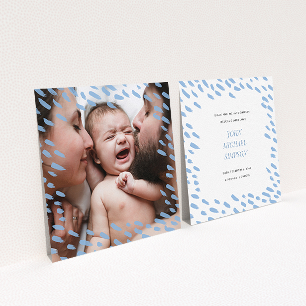 A birth announcement card called "Blue Dashes". It is a square (148mm x 148mm) card in a square orientation. It is a photographic birth announcement card with room for 1 photo. "Blue Dashes" is available as a flat card, with mainly blue colouring.