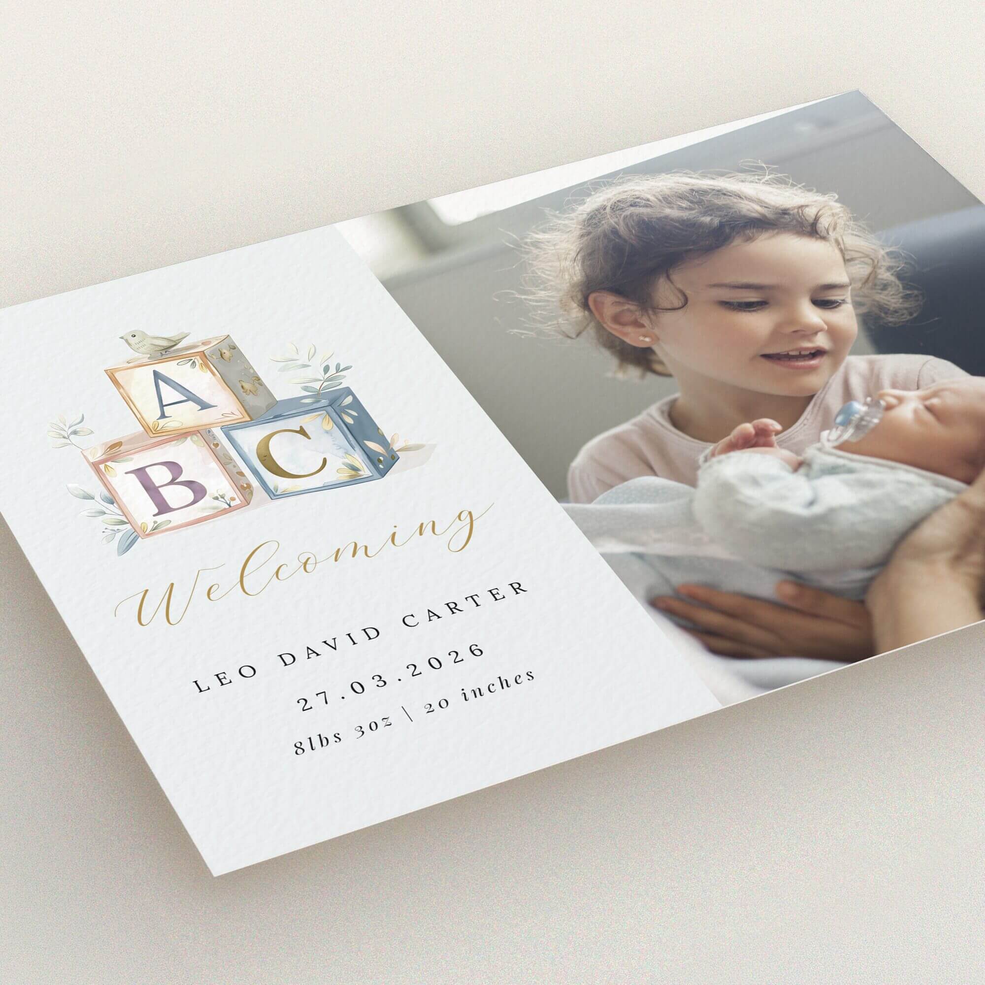 Birth announcement card design featuring two photos and baby ABC blocks illustration.