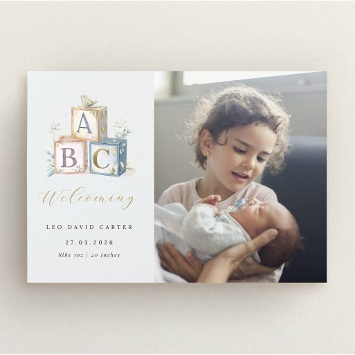 Birth announcement card design featuring two photos and baby ABC blocks illustration.