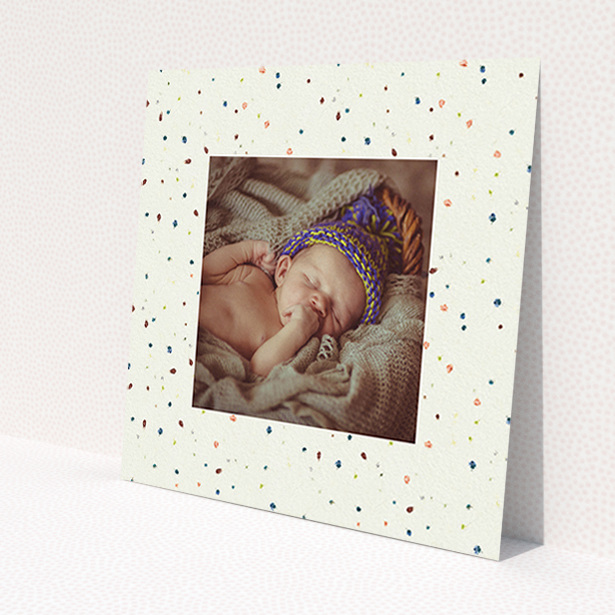A birth announcement card design named 'Dot-dot-dot'. It is a square (148mm x 148mm) card in a square orientation. It is a photographic birth announcement card with room for 1 photo. 'Dot-dot-dot' is available as a flat card, with tones of light cream and blue.