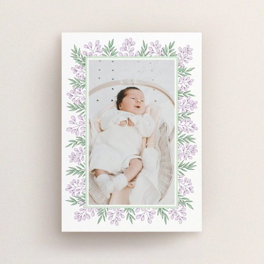 A birth announcement card called "Floral Frame". It is an A6 card in a portrait orientation. It is a photographic birth announcement card with room for 1 photo. "Floral Frame" is available as a flat card, with tones of purple and green.