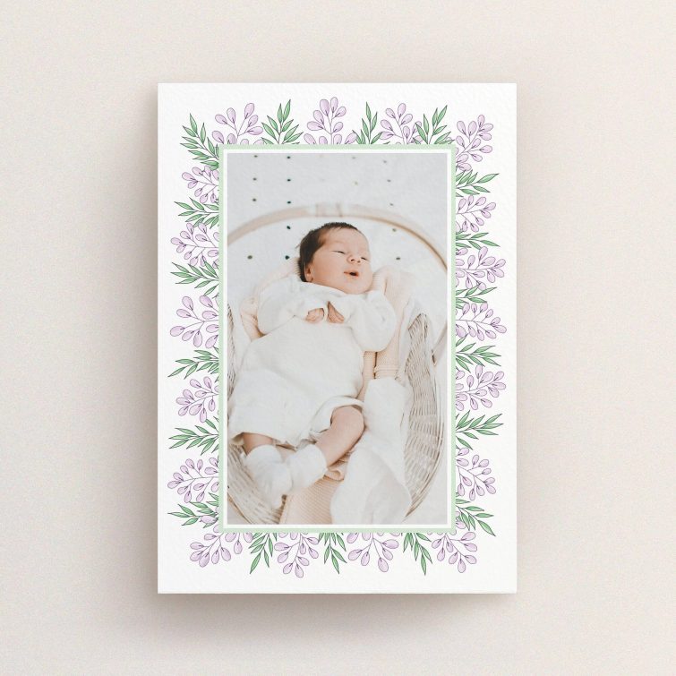 A birth announcement card called "Floral Frame". It is an A6 card in a portrait orientation. It is a photographic birth announcement card with room for 1 photo. "Floral Frame" is available as a flat card, with tones of purple and green.