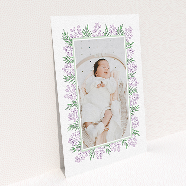 A birth announcement card called "Floral Frame". It is an A6 card in a portrait orientation. It is a photographic birth announcement card with room for 1 photo. "Floral Frame" is available as a flat card, with tones of purple and green.