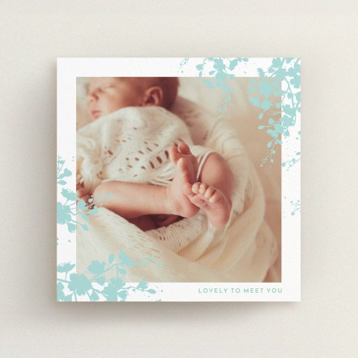 A birth announcement card design called "Forest Frame". It is a square (148mm x 148mm) card in a square orientation. It is a photographic birth announcement card with room for 1 photo. "Forest Frame" is available as a flat card, with tones of blue and white.
