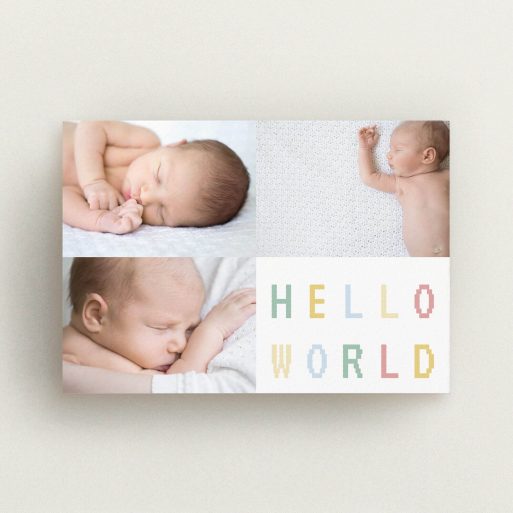 A birth announcement card named "Hello World". It is an A6 card in a landscape orientation. It is a photographic birth announcement card with room for 3 photos. "Hello World" is available as a flat card, with tones of white and green.