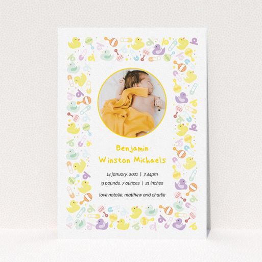 A birth announcement card called "In the Playroom". It is an A5 card in a portrait orientation. It is a photographic birth announcement card with room for 1 photo. "In the Playroom" is available as a flat card, with tones of yellow, white and light purple.