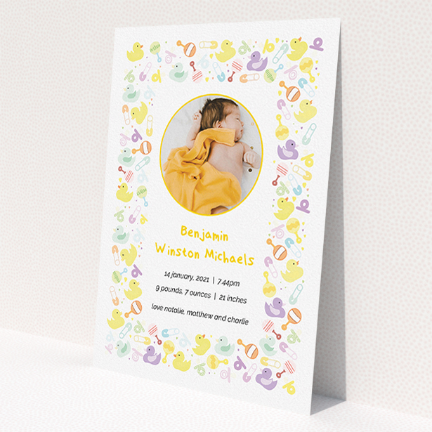 A birth announcement card called 'In the Playroom'. It is an A5 card in a portrait orientation. It is a photographic birth announcement card with room for 1 photo. 'In the Playroom' is available as a flat card, with tones of yellow, white and light purple.