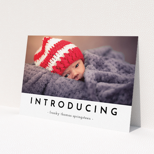 A birth announcement card template titled 'Introducing'. It is an A5 card in a landscape orientation. It is a photographic birth announcement card with room for 1 photo. 'Introducing' is available as a flat card, with mainly white colouring.