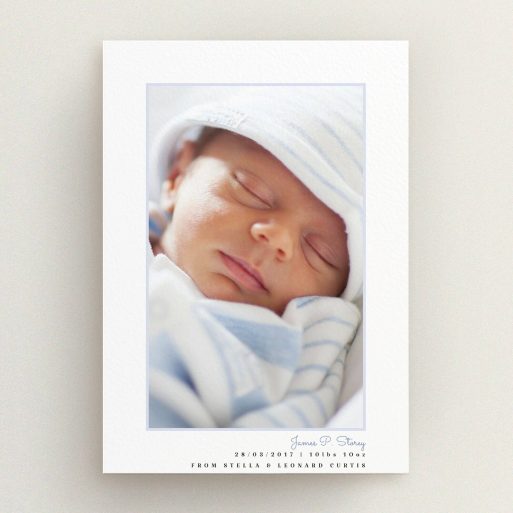 A birth announcement card named "Little Blue Frame". It is an A5 card in a portrait orientation. It is a photographic birth announcement card with room for 1 photo. "Little Blue Frame" is available as a flat card, with tones of white and blue.