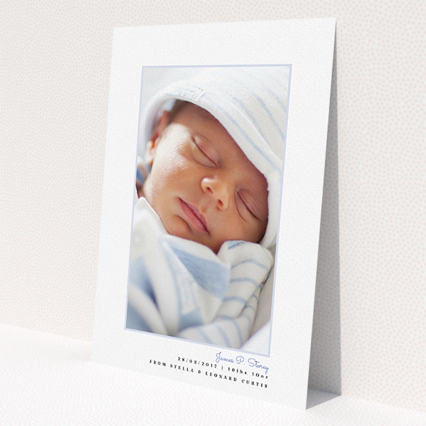 A birth announcement card named "Little Blue Frame". It is an A5 card in a portrait orientation. It is a photographic birth announcement card with room for 1 photo. "Little Blue Frame" is available as a flat card, with tones of white and blue.
