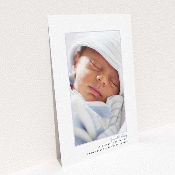 A birth announcement card named "Little Blue Frame". It is an A5 card in a portrait orientation. It is a photographic birth announcement card with room for 1 photo. "Little Blue Frame" is available as a flat card, with tones of white and blue.