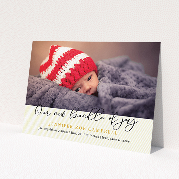 A birth announcement card design titled 'Our New Bundle of Joy'. It is an A6 card in a landscape orientation. It is a photographic birth announcement card with room for 1 photo. 'Our New Bundle of Joy' is available as a flat card, with tones of cream and gold.