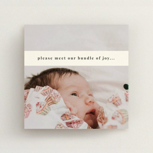 A birth announcement card design named "Our new bundle of joy". It is a square (148mm x 148mm) card in a square orientation. It is a photographic birth announcement card with room for 1 photo. "Our new bundle of joy" is available as a flat card, with mainly cream colouring.