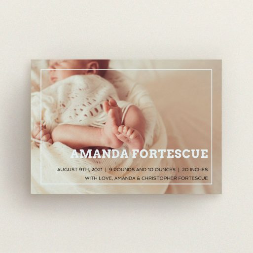 A birth announcement card called "Over Photo Frame". It is an A6 card in a landscape orientation. It is a photographic birth announcement card with room for 1 photo. "Over Photo Frame" is available as a flat card, with mainly light blue colouring.