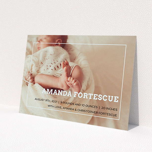 A birth announcement card called "Over Photo Frame". It is an A6 card in a landscape orientation. It is a photographic birth announcement card with room for 1 photo. "Over Photo Frame" is available as a flat card, with mainly light blue colouring.