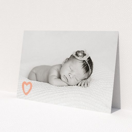 A birth announcement card design called 'Pastel Heart'. It is an A5 card in a landscape orientation. It is a photographic birth announcement card with room for 1 photo. 'Pastel Heart' is available as a flat card, with mainly peach colouring.
