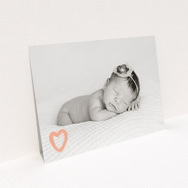 A birth announcement card design called "Pastel Heart". It is an A5 card in a landscape orientation. It is a photographic birth announcement card with room for 1 photo. "Pastel Heart" is available as a flat card, with mainly peach colouring.