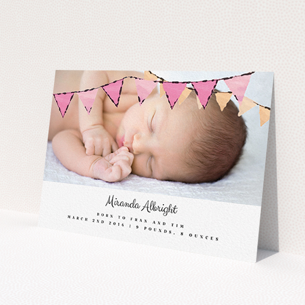 A birth announcement card design named "Pink Bunting". It is an A6 card in a landscape orientation. It is a photographic birth announcement card with room for 1 photo. "Pink Bunting" is available as a flat card, with tones of pink and white.