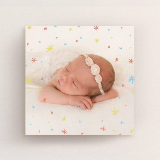 A birth announcement card template titled "Playground Stars". It is a square (148mm x 148mm) card in a square orientation. It is a photographic birth announcement card with room for 1 photo. "Playground Stars" is available as a flat card, with mainly red colouring.