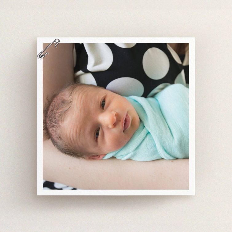 A birth announcement card design titled "Put a pin in it". It is a square (148mm x 148mm) card in a square orientation. It is a photographic birth announcement card with room for 1 photo. "Put a pin in it" is available as a flat card, with mainly white colouring.