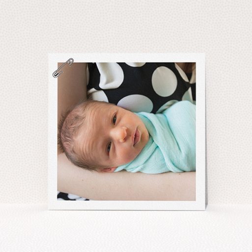 A birth announcement card design titled "Put a pin in it". It is a square (148mm x 148mm) card in a square orientation. It is a photographic birth announcement card with room for 1 photo. "Put a pin in it" is available as a flat card, with mainly white colouring.