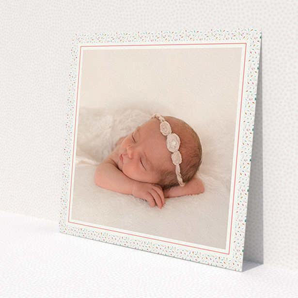 A birth announcement card design titled 'Sprinkle Frame'. It is a square (148mm x 148mm) card in a square orientation. It is a photographic birth announcement card with room for 1 photo. 'Sprinkle Frame' is available as a flat card, with tones of cream, red and blue.