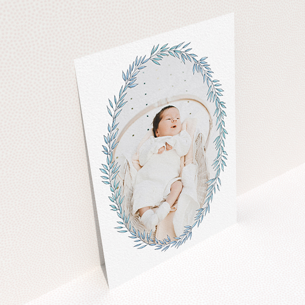 A birth announcement card design called "Tussled Wreath". It is an A6 card in a portrait orientation. It is a photographic birth announcement card with room for 1 photo. "Tussled Wreath" is available as a flat card, with tones of blue and white.