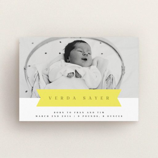 A birth announcement card named "Yellow Banner". It is an A6 card in a landscape orientation. It is a photographic birth announcement card with room for 1 photo. "Yellow Banner" is available as a flat card, with tones of yellow and white.