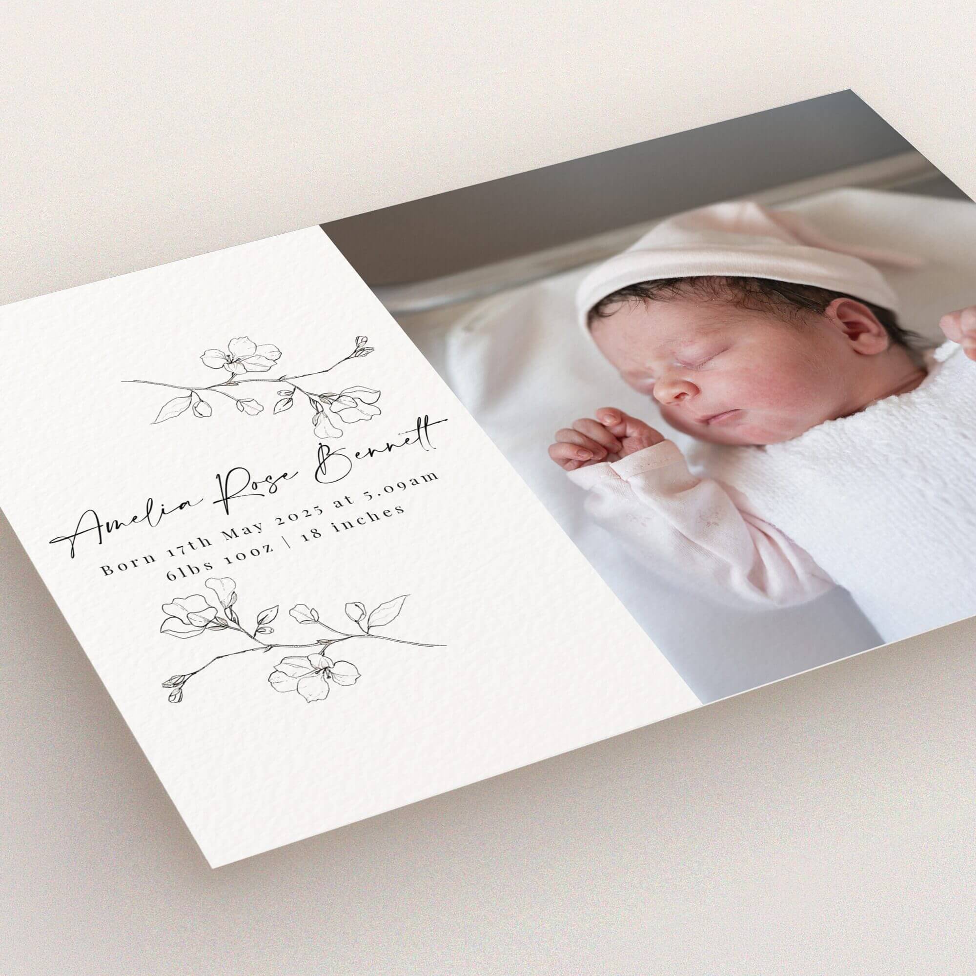 Elegant birth announcement card design with floral illustrations and one photo of a newborn baby.