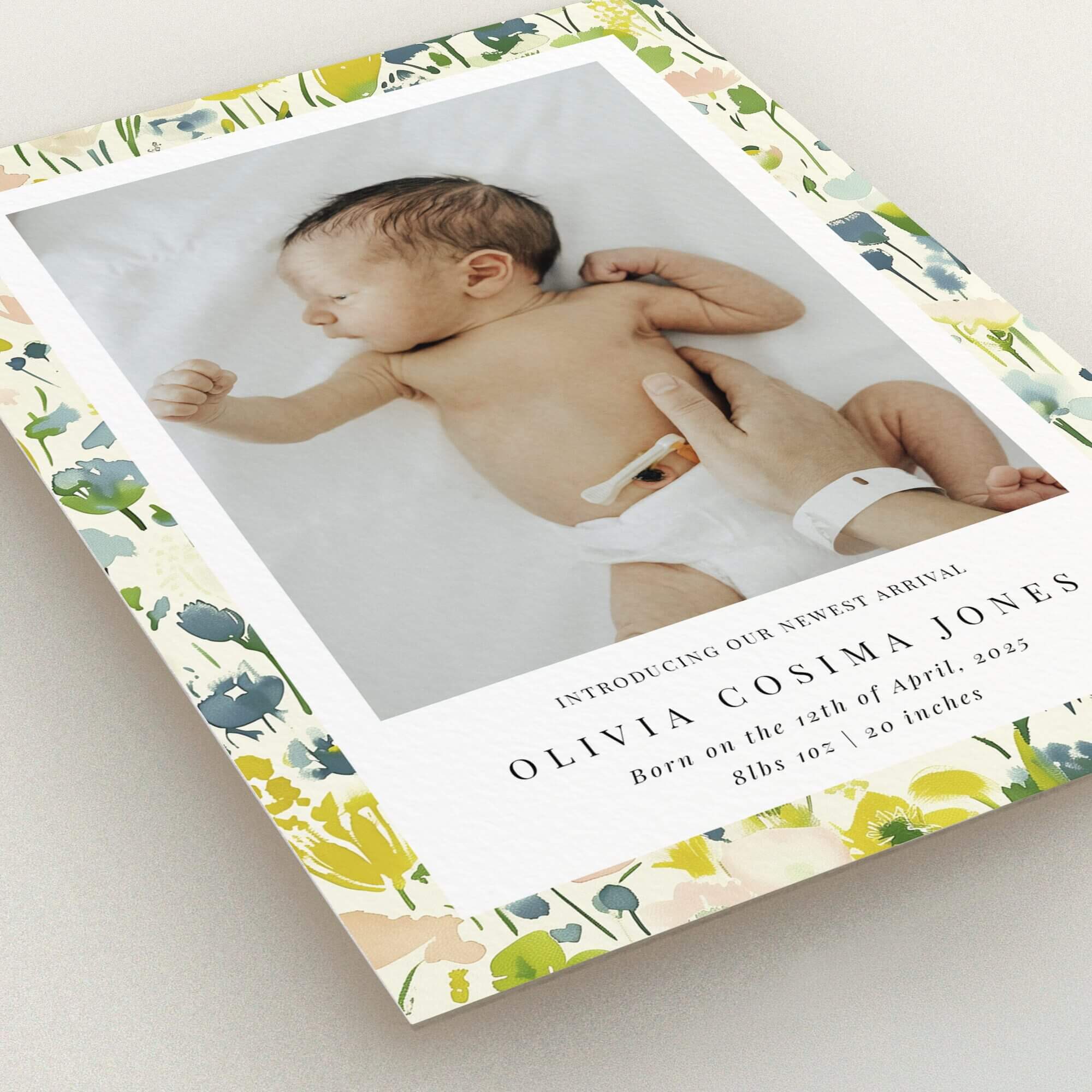 Floral birth announcement card with one baby photo.