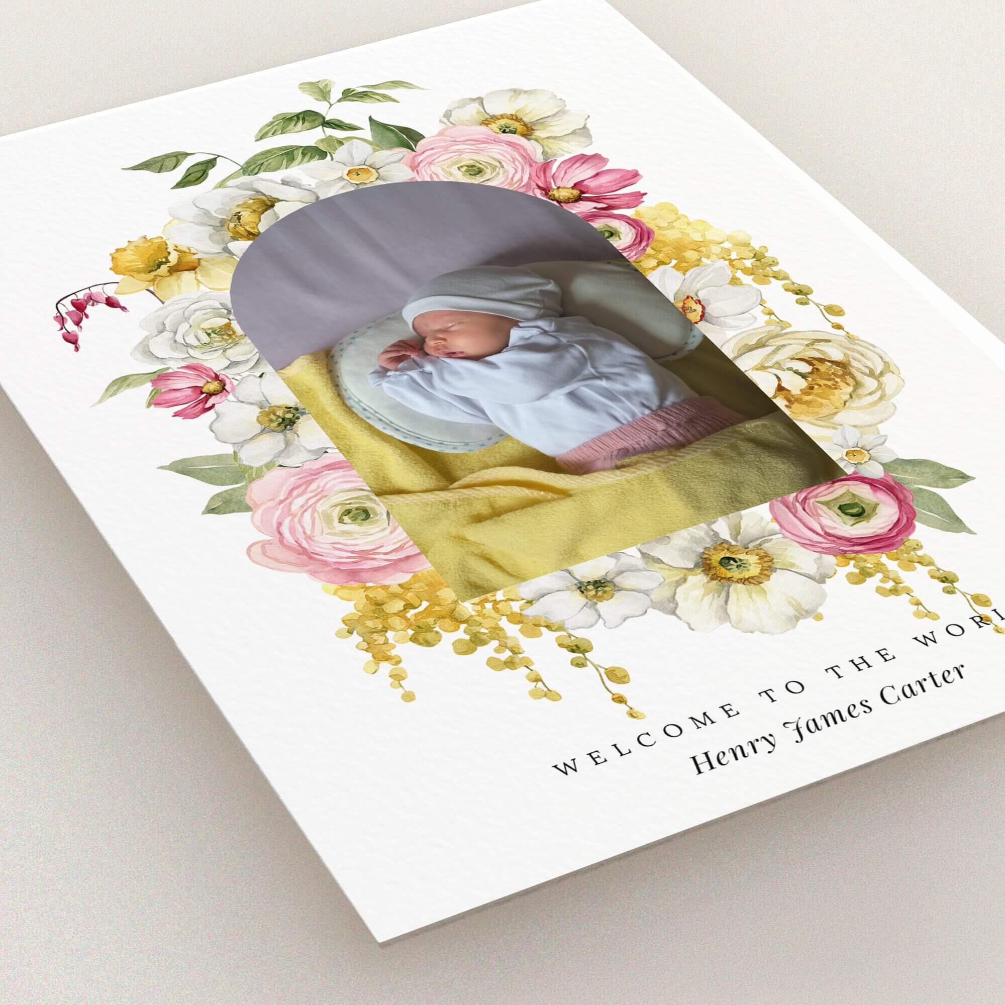 Floral birth announcement card with one baby photo in the centre surrounded by colourful flowers.