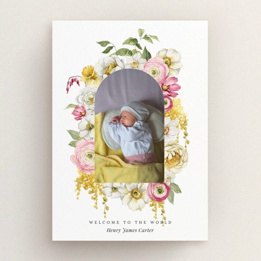 Floral birth announcement card with one baby photo in the centre surrounded by colourful flowers.