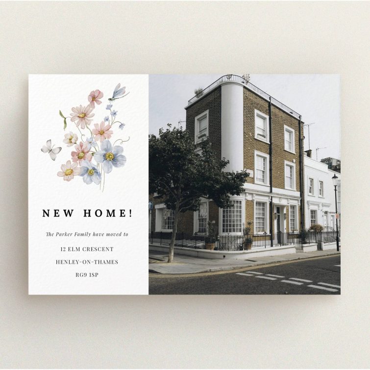 Floral design change of address card with one photo of a traditional house.