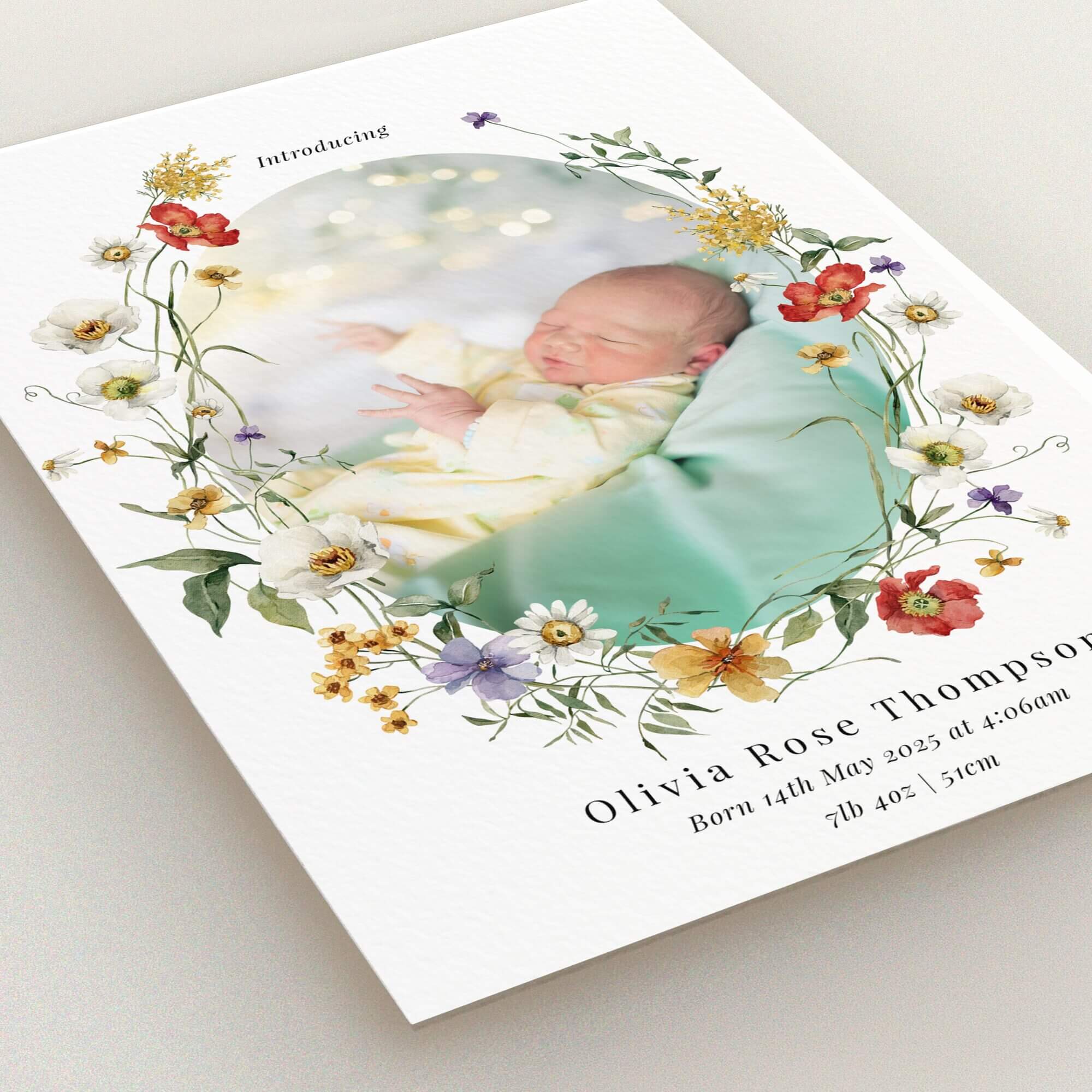 Floral birth announcement card with one baby photo surrounded by decorative flowers.