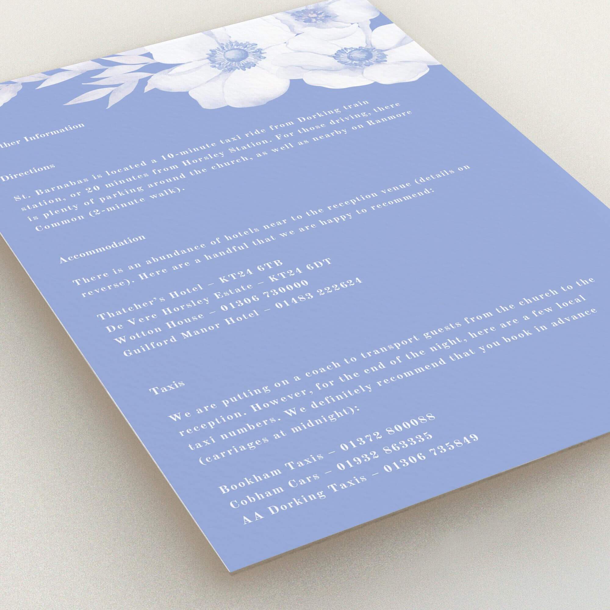 Floral wedding invitation card design with accommodation and transport information, featuring delicate flowers in blue.