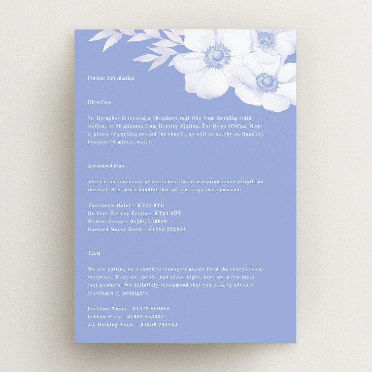 Floral wedding invitation card design with accommodation and transport information, featuring delicate flowers in blue.