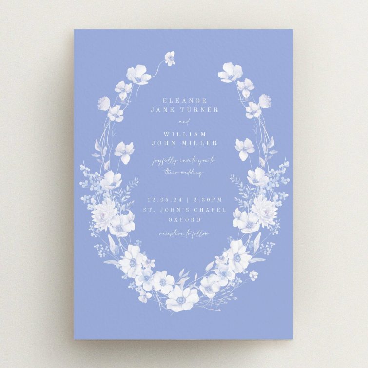 Elegant floral wedding invitation design with wreath motif on a blue background, no photos.