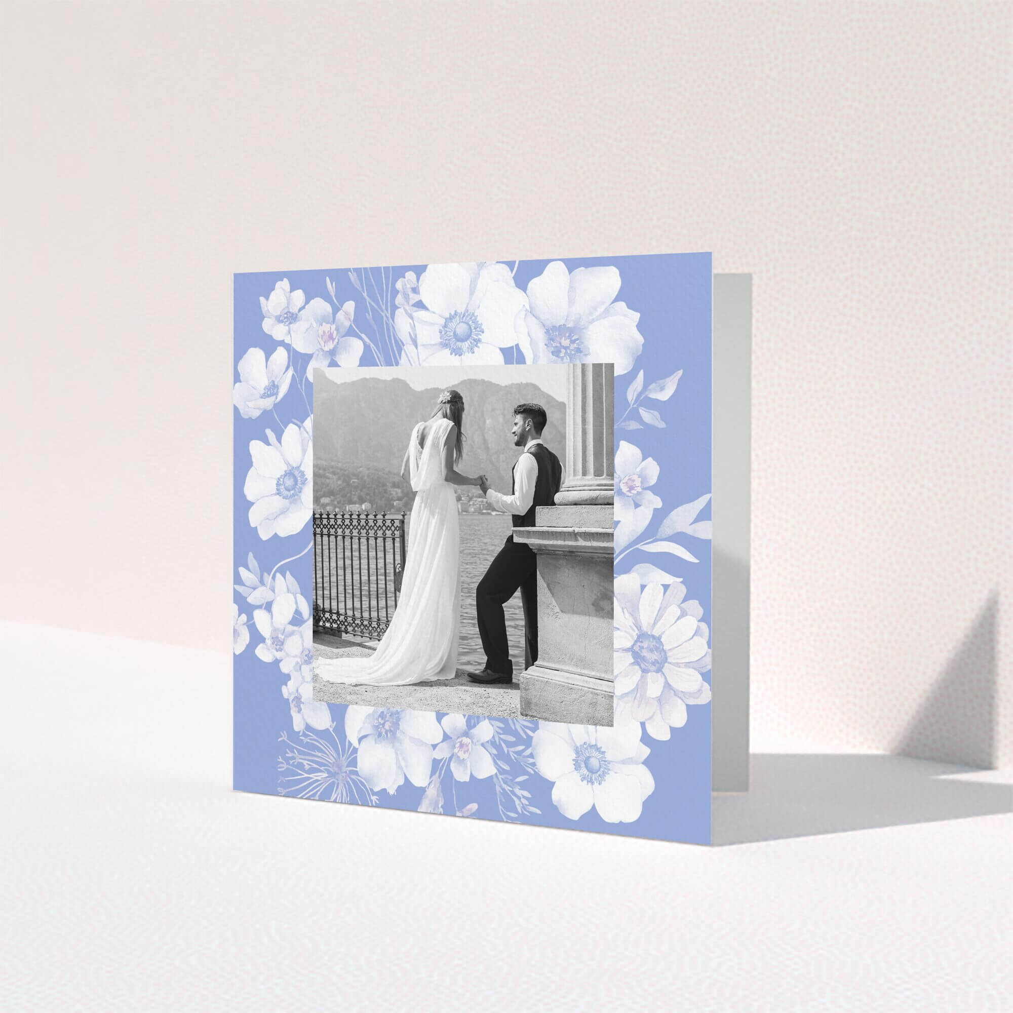 Floral wedding thank you card design with a black and white photo of a couple.