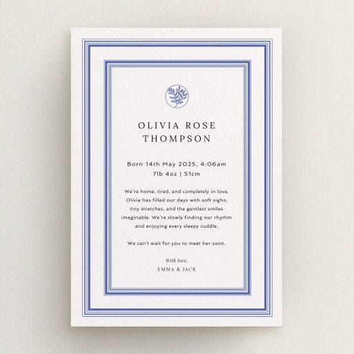 Elegant birth announcement card design with one photo and floral accent in blue borders.