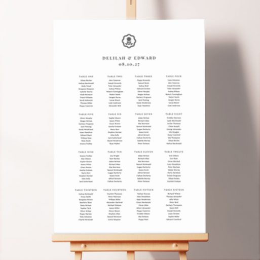 Personalized Botanical Crest Seating Plans featuring a charming black-and-white crest design with an illustrated flower, adding a touch of sophistication to your wedding day.. This one is formatted for 16 tables.