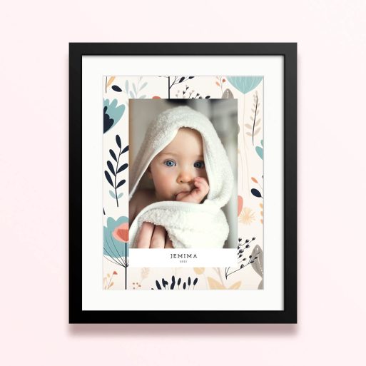 Framed and mounted photo print with floral background and one photo of a baby.