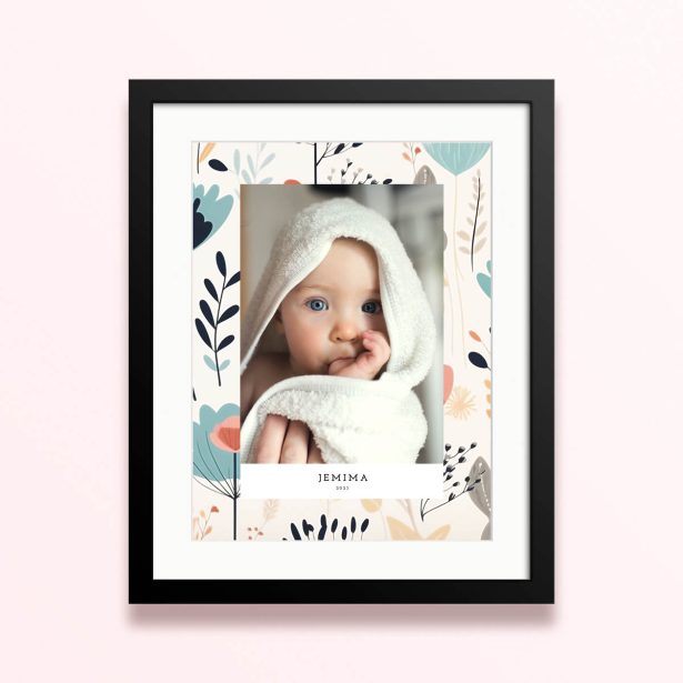 Framed and mounted photo print with floral background and one photo of a baby.